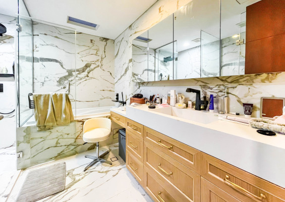 fully furnished condo with a balcony overlooking the city skyline