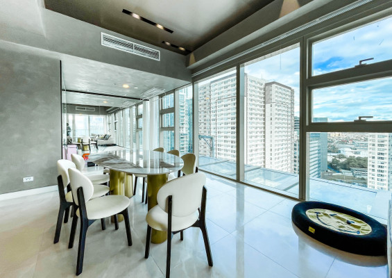 fully furnished condo with a balcony overlooking the city skyline