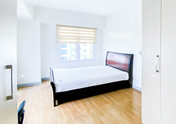 semi-furnished corner condo boasts a spacious balcony and a bedroom