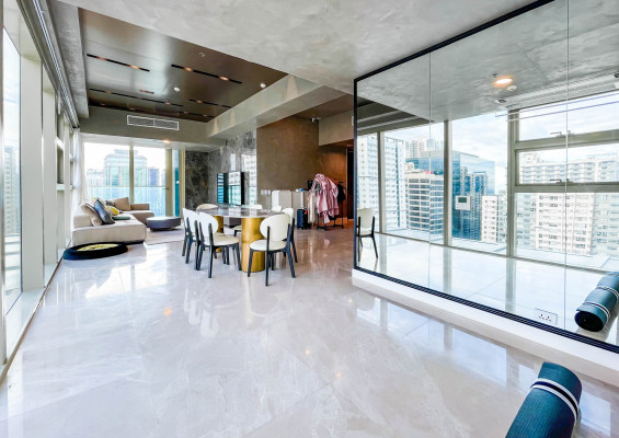 fully furnished condo with a balcony overlooking the city skyline