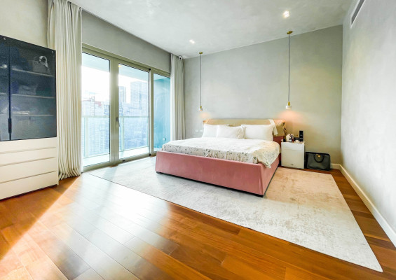 fully furnished condo with a balcony overlooking the city skyline
