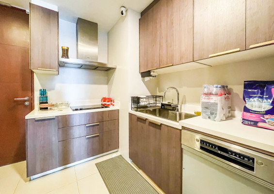 fully furnished condo with a balcony overlooking the city skyline