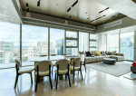 fully furnished condo with a balcony overlooking the city skyline