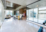 fully furnished condo with a balcony overlooking the city skyline