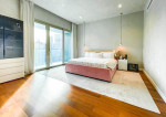 fully furnished condo with a balcony overlooking the city skyline