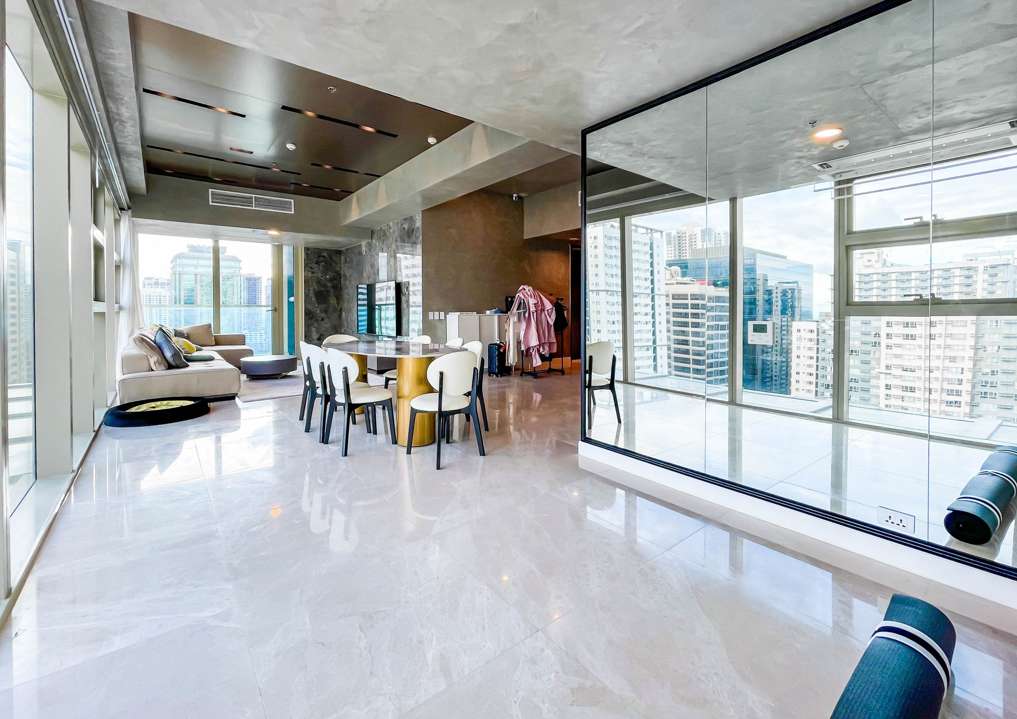 fully furnished condo with a balcony overlooking the city skyline photo 1